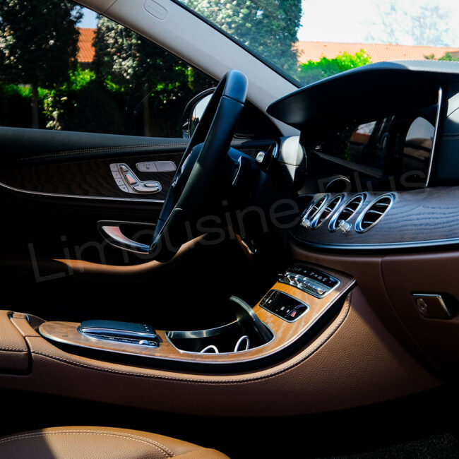 The luxurious interior of a Limousine Plus VIP vehicle, featuring rear-seat entertainment screens and premium leather seats for ultimate comfort.
