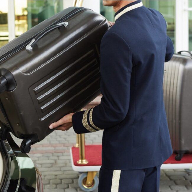 Chauffeur Loading Luggage into Luxury Vehicle