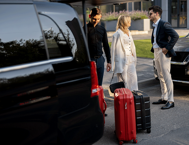 Chauffeur assisting a couple with their luggage for a Mercedes Vito airport transfer in Istanbul, ensuring a smooth start to their journey.