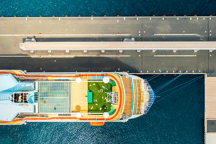 Top-down aerial view of a large cruise ship at the port, for passengers needing a private transfer service in Istanbul.