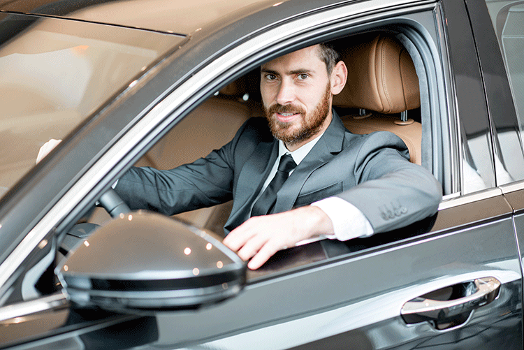 A professional and experienced Limousine Plus chauffeur sitting confidently in the driver's seat of a luxury car in Istanbul.